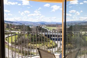 a view from a balcony with two chairs and a window at Tower Apartments in Cluj-Napoca