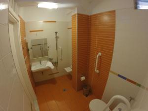 a bathroom with a sink and a toilet and a mirror at Mirto Apartments in Afissos