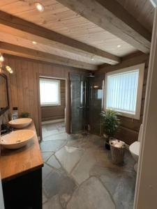 a large bathroom with two sinks and a shower at Cabin with Porsche to rent in Sogndal