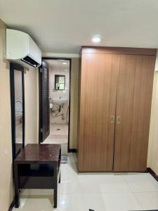 a bathroom with a wooden cabinet and a sink at 3-BR Unit in the Center of Cebu in Cebu City