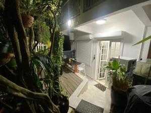 a living room with plants and a porch at Appartement charmant au Gosier avec terrasse de 32 m² in Le Gosier
