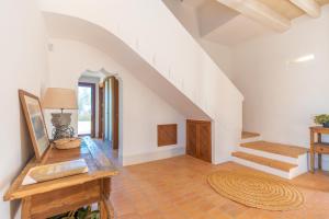 a living room with a table and a staircase at Son Catxo in Búger