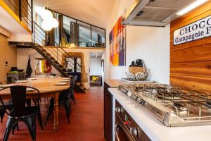 a restaurant with a counter and a table with chairs at La Trêve - Mas 12 personnes rénové avec Piscine in Saint-Julien-du-Serre