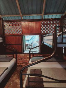 a room with two bunk beds and a window at Jungle Zen Janda Baik Campsite in Kampung Janda Baik