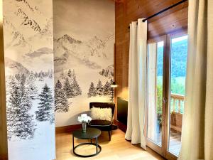 a living room with a wall mural of mountains at Le Paret chambres d'h&ocirc;tes de charme & spa in Manigod