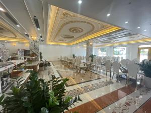 a banquet hall with chairs and tables in a room at Đông Thắm Hotel in Diện Biên Phủ