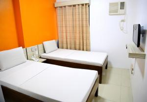 Postel nebo postele na pokoji v ubytování Travelbee Business Inn