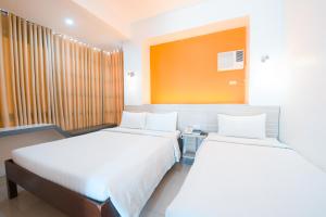 Postel nebo postele na pokoji v ubytování Travelbee Business Inn