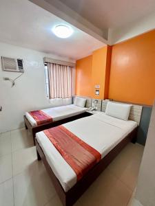 Postel nebo postele na pokoji v ubytování Travelbee Business Inn