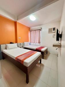 Postel nebo postele na pokoji v ubytování Travelbee Business Inn