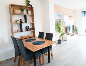 a dining room with a wooden table and chairs at APARTMAN D&D , KRK-VRH in Vrh