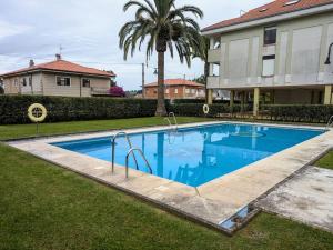 a large blue swimming pool in front of a house at Riberuca in Suances +20 photos