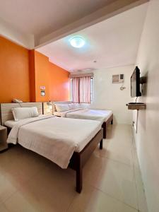 Postel nebo postele na pokoji v ubytování Travelbee Business Inn
