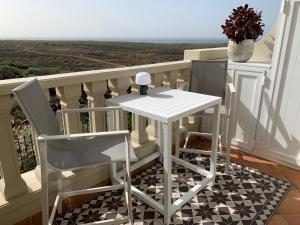 a white table and two chairs on a balcony at Paraiso Ocean Panorama in Palm-Mar