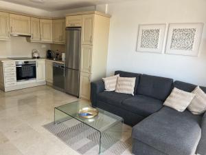 a living room with a couch and a glass table at Paraiso Ocean Panorama in Palm-Mar