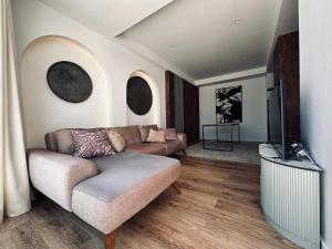 a living room with a couch and a flat screen tv at Palastura Apartments in Ulcinj