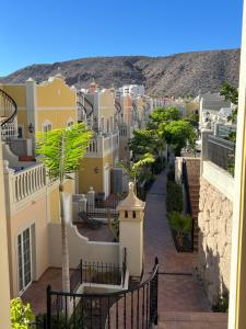 a city with a palm tree and buildings at Paraiso Ocean Panorama in Palm-Mar