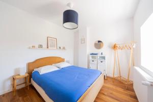 a bedroom with a blue bed in a room at Domaine de La Baisse in Saint-Étienne-la-Varenne +34 photos