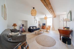 a living room with a couch and a piano at Domaine de La Baisse in Saint-Étienne-la-Varenne