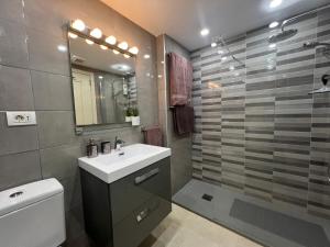 a bathroom with a sink and a toilet and a shower at Paraiso Ocean Panorama in Palm-Mar +15 photos