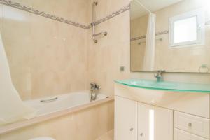 a bathroom with a sink and a tub and a mirror at Cas Ferrer -Bonaire- in Cielo de Bonaire  +24 photos