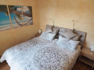 a bedroom with a bed with white sheets and pillows at Mediterranes Gelbes Haus Pool Sauna in Königheim