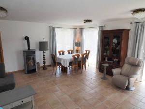 a living room with a dining room table and chairs at Mediterranes Gelbes Haus Pool Sauna in Königheim