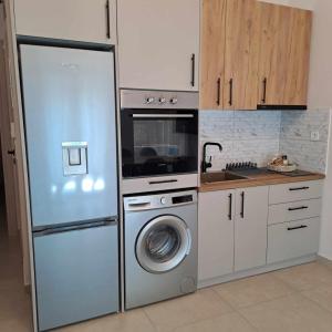 a kitchen with a refrigerator and a washing machine at Lydia's Apartment in Tripolis