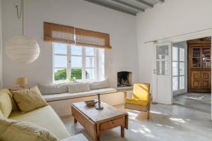 a living room with a couch and a table at Amazing Sea View, Mykonos Cycladic Villa, Priv Pool in Mýkonos City