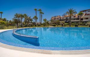Una gran piscina azul con palmeras y edificios. en 2 Bedroom Cozy Apartment In Vera, en Vera