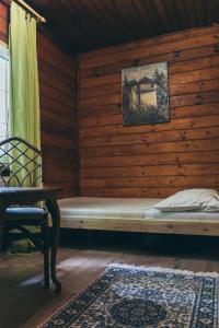 a bed in a room with a wooden wall at Chopina 43 in Karpacz