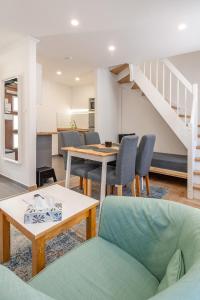 a living room with a table and chairs and a staircase at Monbuhim Twin in Veszprém