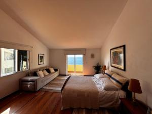 a bedroom with a bed and a couch at Bela Vigia in Jardim do Mar +67 photos