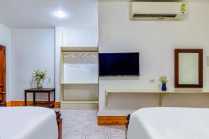 a hotel room with two beds and a flat screen tv at 万象莉莉酒店 Lilyhotel in Vientiane +24 photos