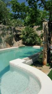 a large swimming pool with a blue pool at Casa Louise - Piscine et jacuzzi privatifs in Sainte-Maxime