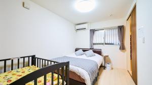 Ένα ή περισσότερα κρεβάτια σε δωμάτιο στο M HOUSE 新开业优惠！独栋别墅鹤桥站步行5分钟！超便利！难波日本桥神户环球影城奈良一线直达