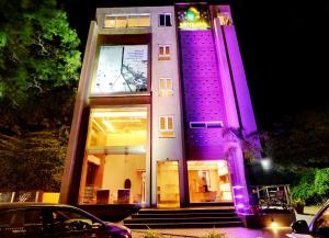 a building with purple lights on the side of it at SANKAMA The Boutique Hotel in Dāvangere