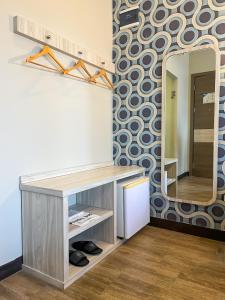a dressing room with a vanity and a mirror at Hotel 88 Kedungsari - Kedungdoro By WH in Surabaya