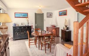 a dining room with a table and chairs in a room at Beautiful Home In Plouha With Wifi in Plouha