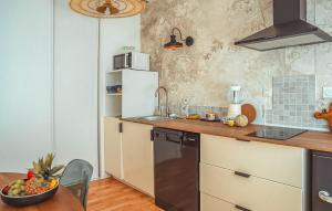 a kitchen with a sink and a refrigerator at Stunning Apartment In Saint-Renan in Saint-Renan +9 photos