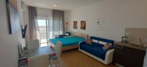 a small room with a blue bed and a couch at Your Home Montenegro in Dobra Voda +236 photos