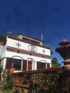 a white building with a flag on top of it at VILLA ANITA 1930 LLAFRANC casa con piscina privada in Llafranc