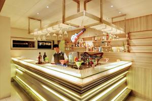 a man standing behind a bar in a restaurant at SANKAMA The Boutique Hotel in Dāvangere
