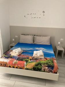 a bedroom with a bed with a painting on it at Cavallerizza home in Naples +29 photos