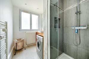 a bathroom with a shower and a washing machine at Welcome to Karl House in Champigny-sur-Marne
