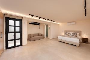 a large bedroom with a bed and a couch at Villa Cristina in Elounda +38 photos