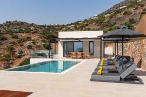 a villa with a swimming pool and a house at Villa Cristina in Elounda