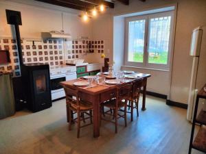 a kitchen with a large wooden table with chairs at Maison Vintage in Marat +15 photos