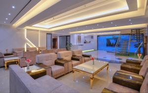 a living room with a couch and a table at Wingston A TreeHouse Hotel, Mathura in Mathura
