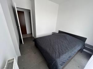 ein Schlafzimmer mit einem Bett in der Zimmerecke in der Unterkunft Apartament Katowice Tysiąclecie in Kattowitz